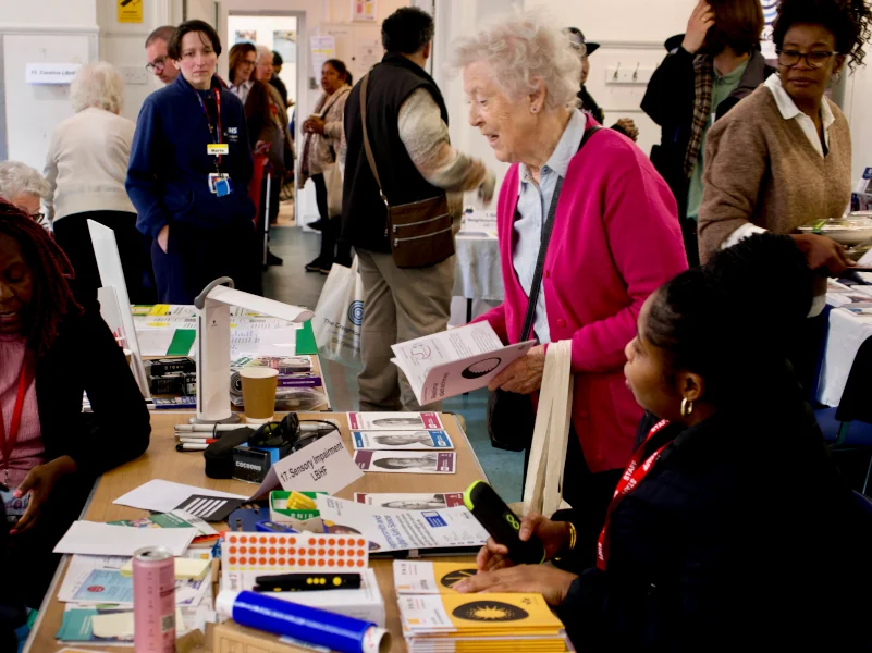 Creighton Community Centre event older woman being helped
