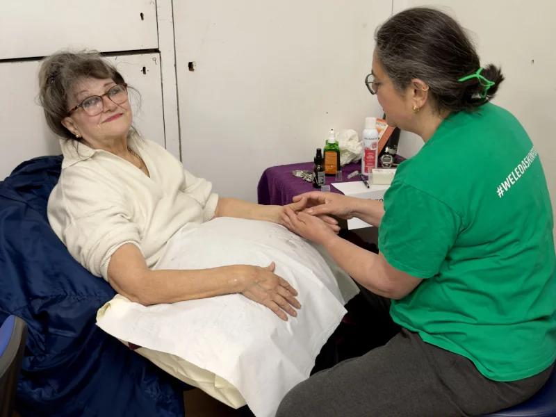 Creighton Community Centre event, woman being helped by a volunteer