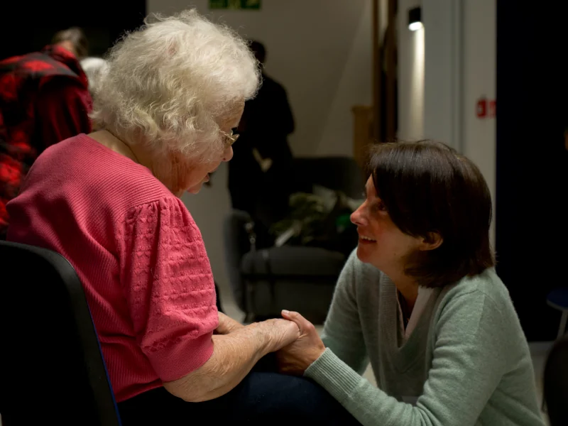 a volunteer speaking with an older woman