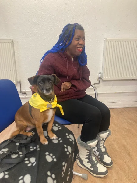 Labake with a puppy at the Pets as Therapy program